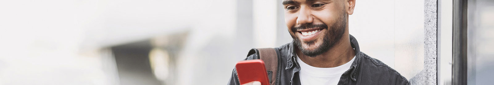 Young man using phone in public