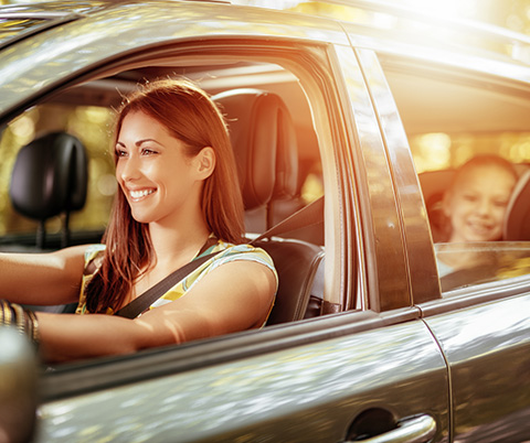 Mother and daughter riding in car