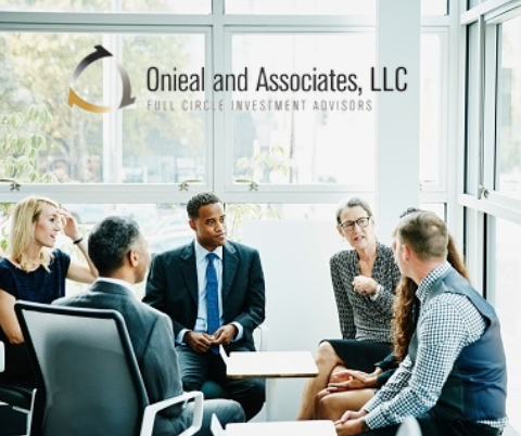 People meeting in a board room. Onieal and Associates, LLC.