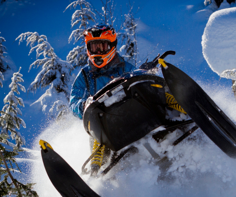 Person snowmobiling through the snow