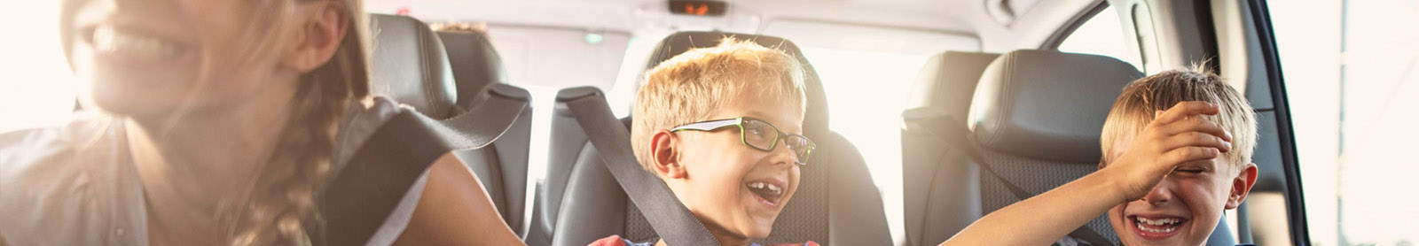 Group of kids riding in new car