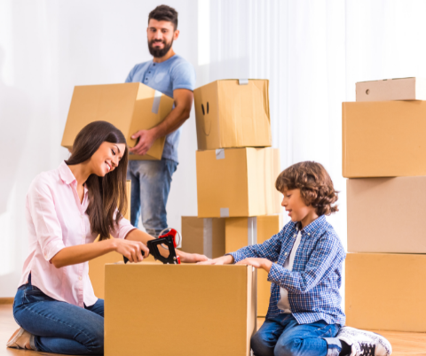 Family unpacking boxes after moving into a new house